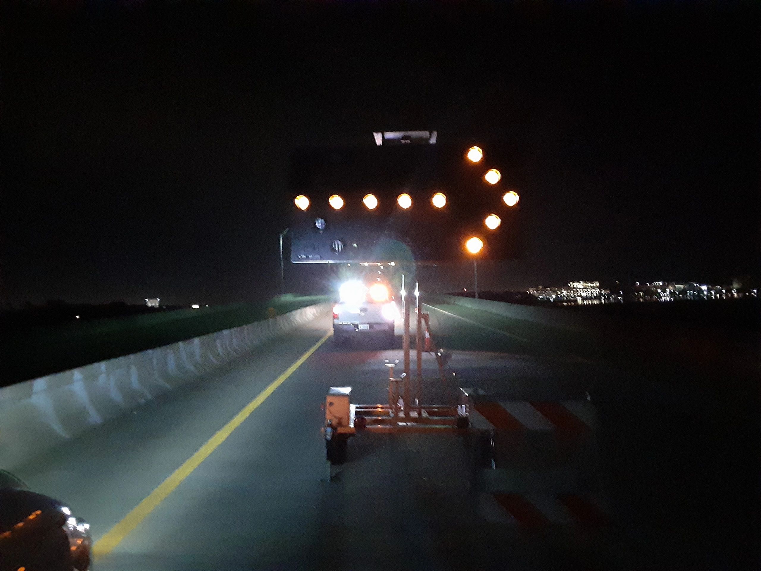 Nighttime highway with amber warning lights